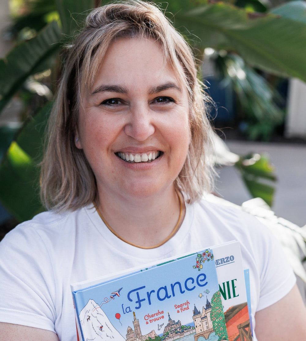 Portrait of Clotilde French Bookstore holding books in her hands